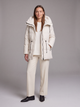 Women's padded hooded parka coat shown in beige and black