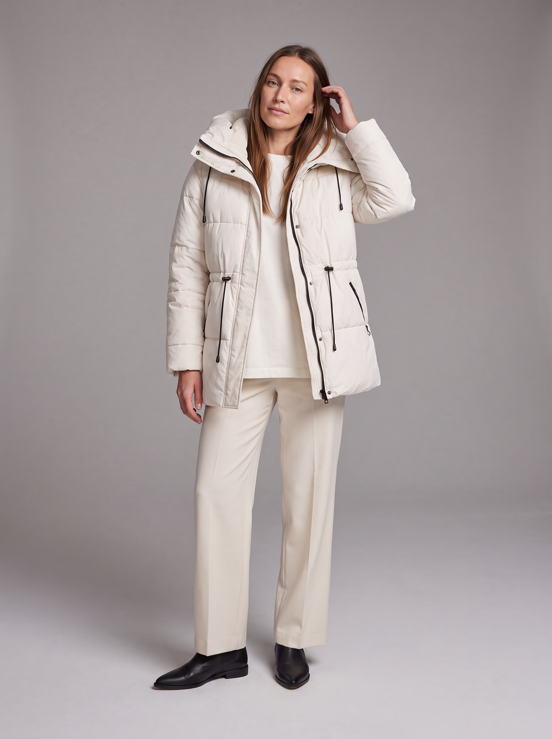 Women's padded hooded parka coat shown in beige and black