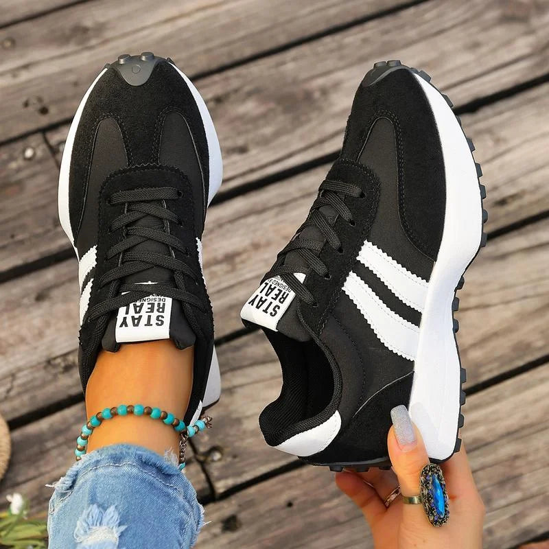 Women's black and white lace-up sneaker with striped side detail