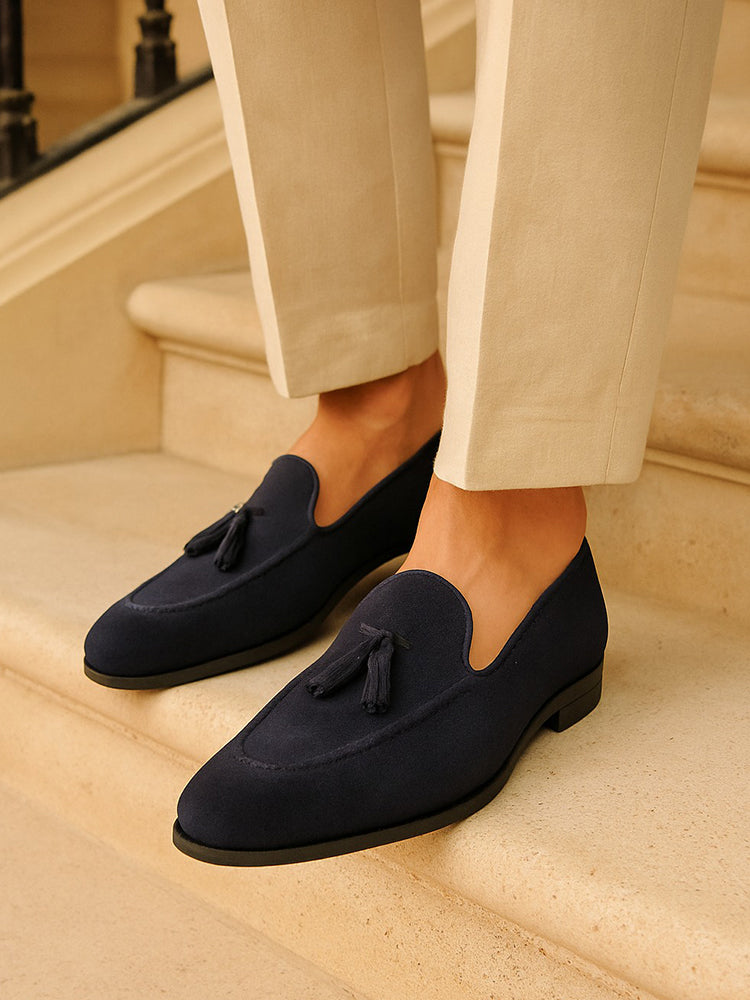 Men's navy tassel loafers with almond toes and low heels