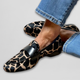 Women's black animal print slip-on loafers with low block heels