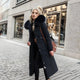 Women's long padded hooded coat with faux fur trim