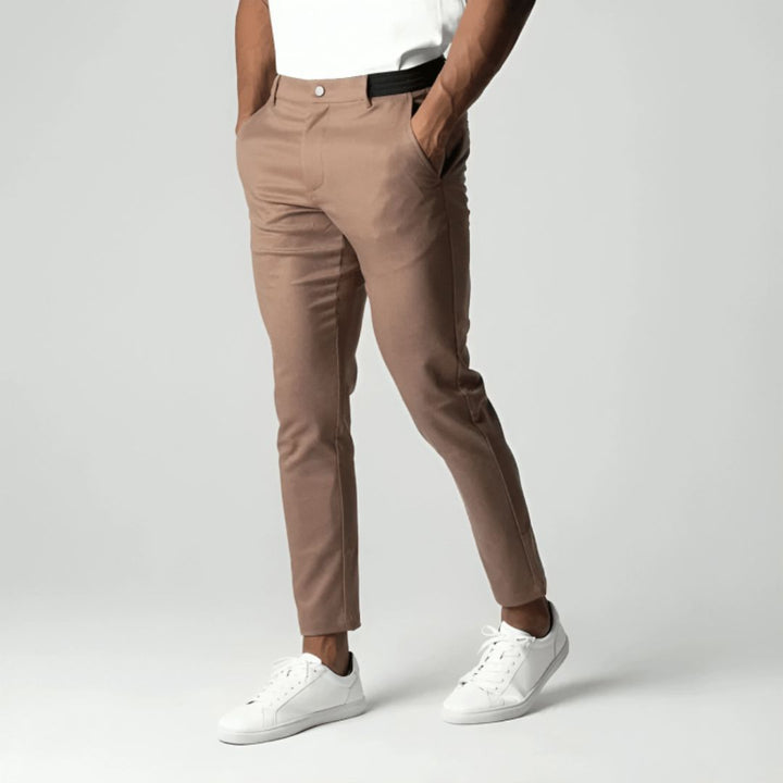 Men's slim tapered cropped chino pants shown in black and navy with side pockets and button closure