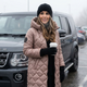 Women's quilted hooded long coat shown in pink and black
