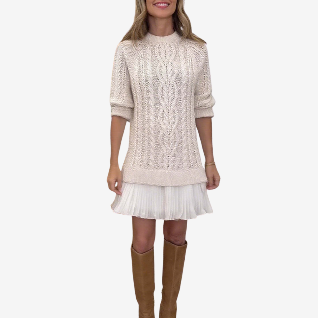 Women's cable knit dress with crew neck, long sleeves and pleated hem