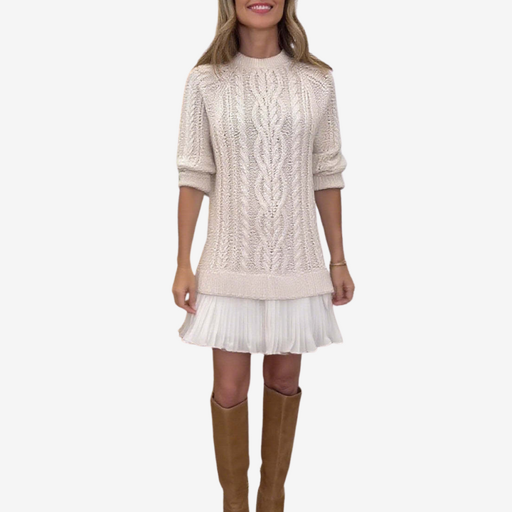 Women's cable knit dress with crew neck, long sleeves and pleated hem
