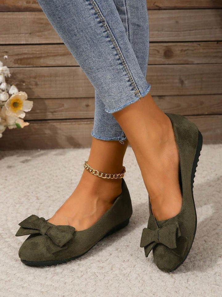 Bow detail flat loafers shown in black and dark green