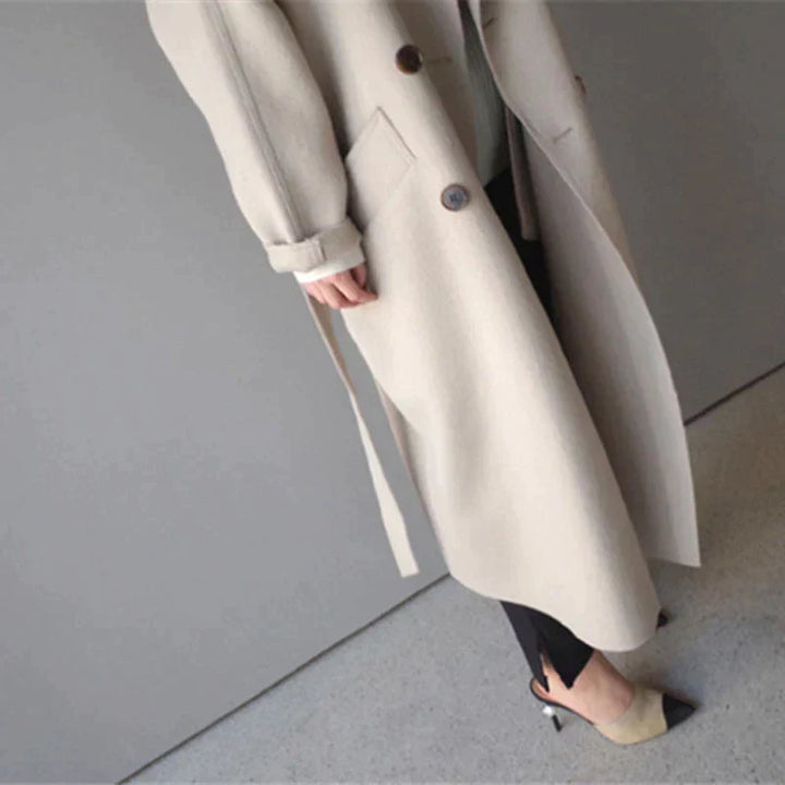 Women's longline button-front coat with notched lapels and side pockets