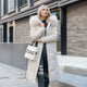 Women's long padded hooded coat with faux fur trim