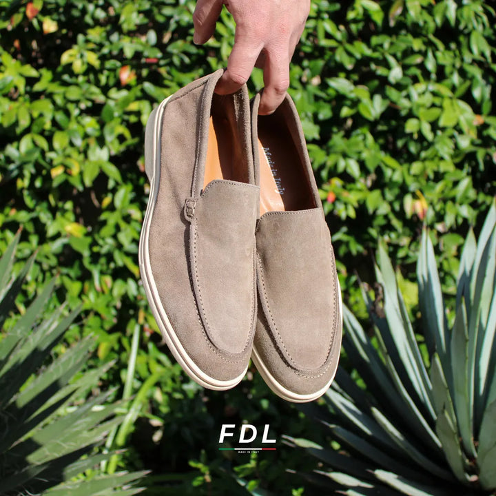 Beige moccasin loafers with rounded toes, stitched detailing and low soles