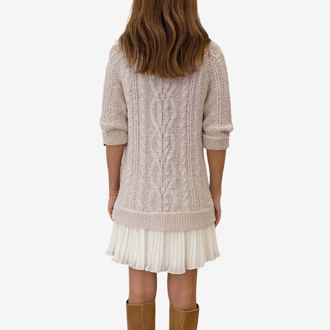 Women's cable knit dress with crew neck, long sleeves and pleated hem