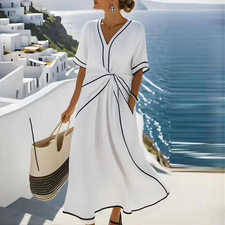 Women's wrap midi dress with V-neckline, short sleeves, and contrast trim in blue