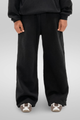 Man wearing black wide-leg sweatpants with an elastic waistband and side pockets