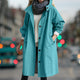 Women's hooded longline rain coat with button front and gathered cuffs