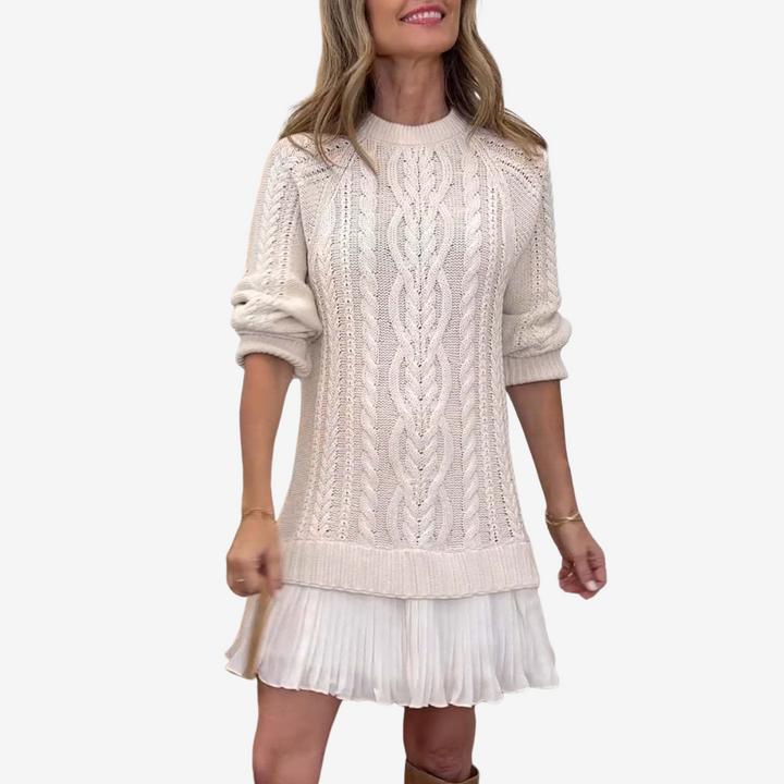 Women's cable knit dress with crew neck, long sleeves and pleated hem