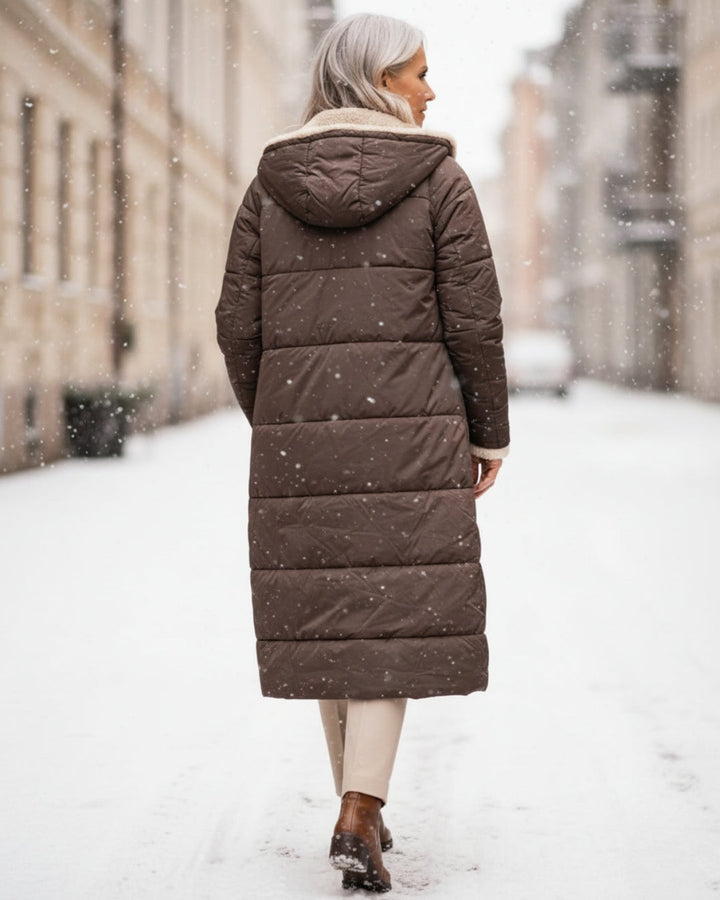 Women's long reversible quilted coat with contrasting trim and hooded collar