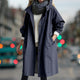 Women's hooded longline rain coat with button front and gathered cuffs