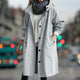 Women's hooded longline rain coat with button front and gathered cuffs