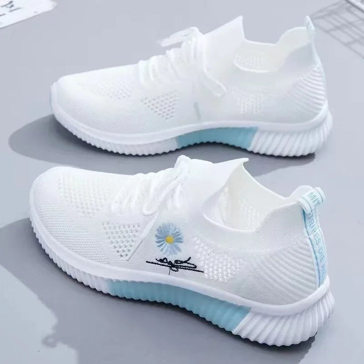 Women's textured lace-up sneakers with floral side detail and ridged soles