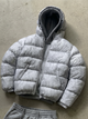 Men's hooded quilted puffer jacket shown in gray and black variants