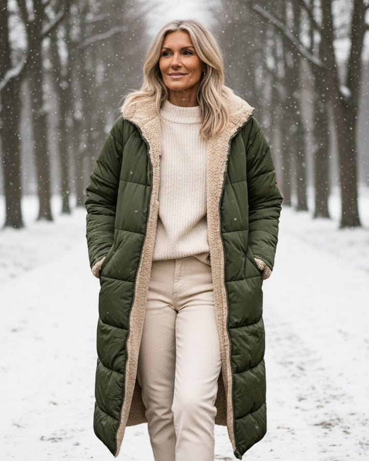 Women's long reversible quilted coat with contrasting trim and hooded collar