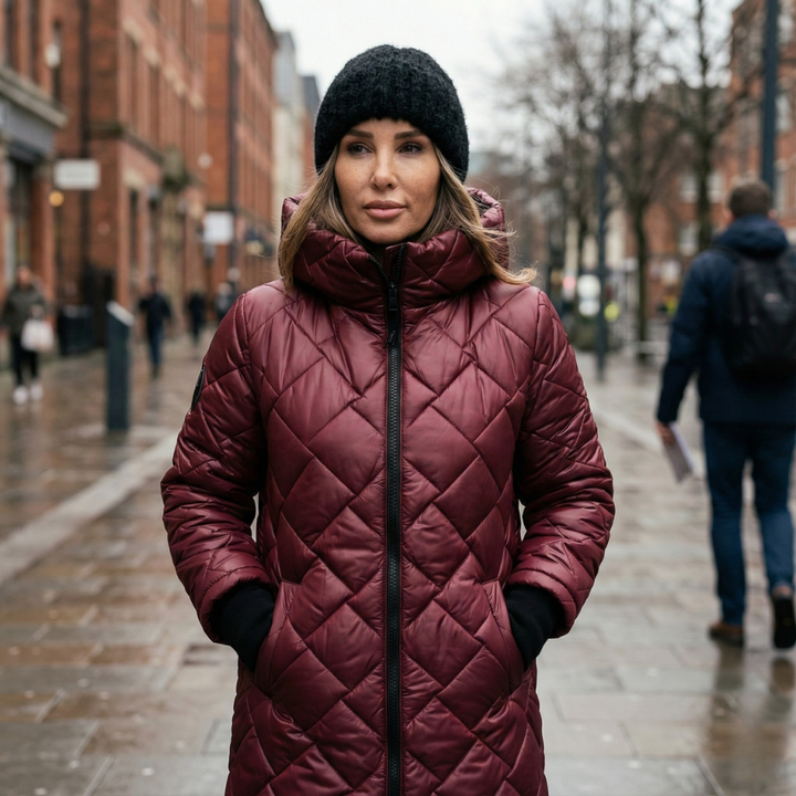 Women's quilted hooded long coat shown in pink and black