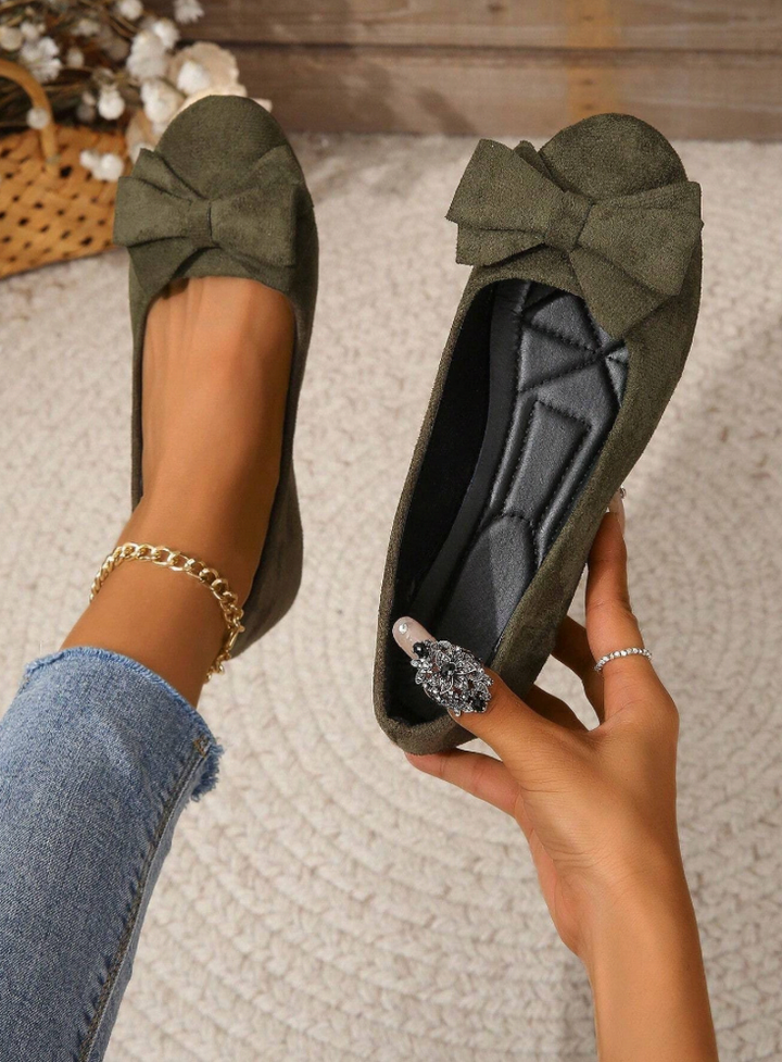 Bow detail flat loafers shown in black and dark green