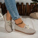 Women's low-profile lace-up moccasin shoes with stitched trim and flat textured soles