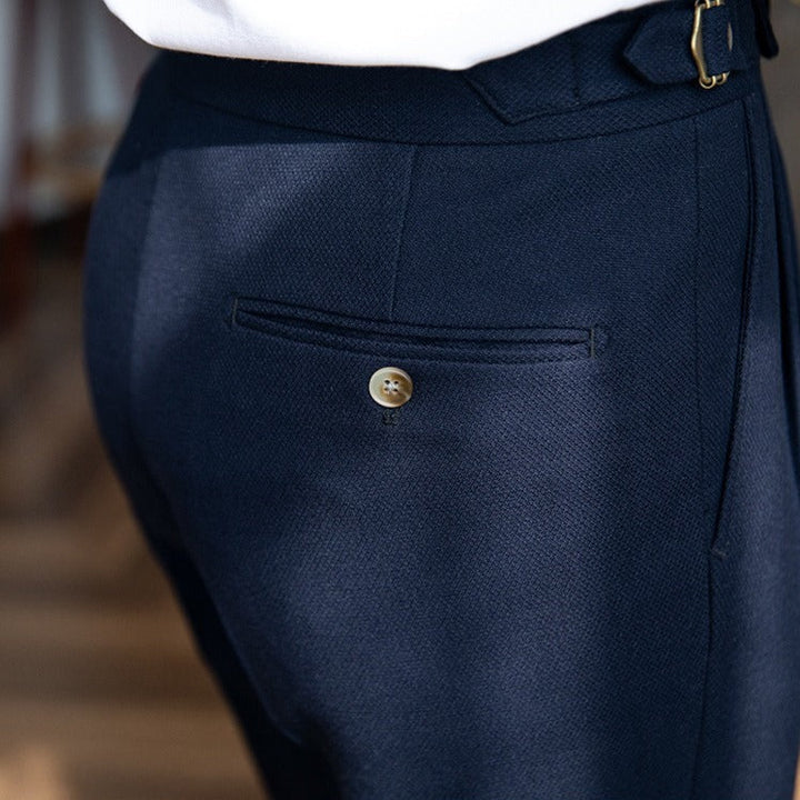 Pleated trousers with side waist tabs, belt loops and cuffed hems