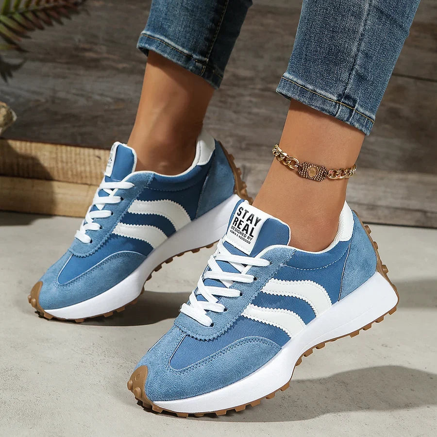 Women's black and white lace-up sneaker with striped side detail