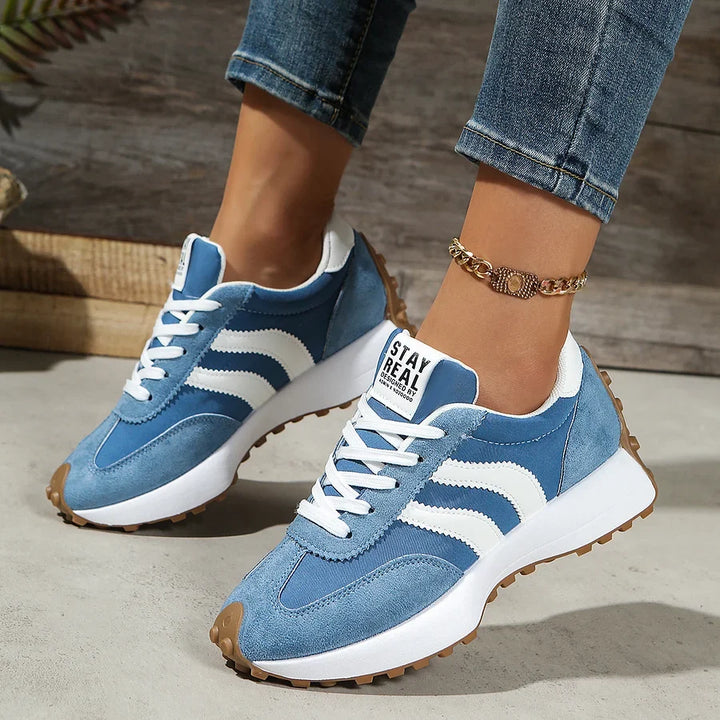 Women's black and white lace-up sneaker with striped side detail