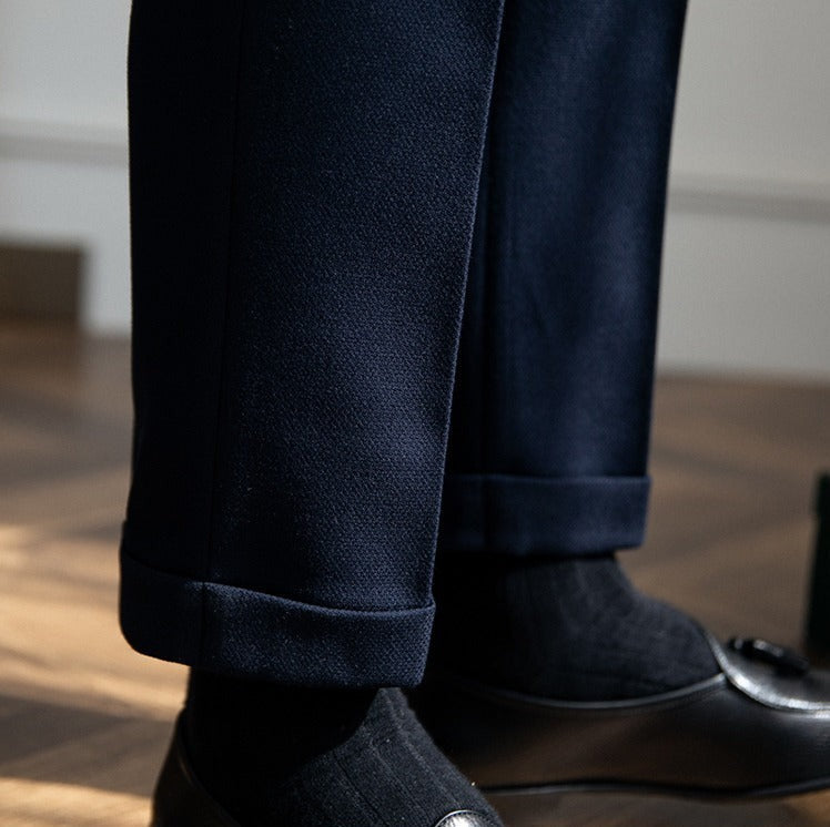 Pleated trousers with side waist tabs, belt loops and cuffed hems