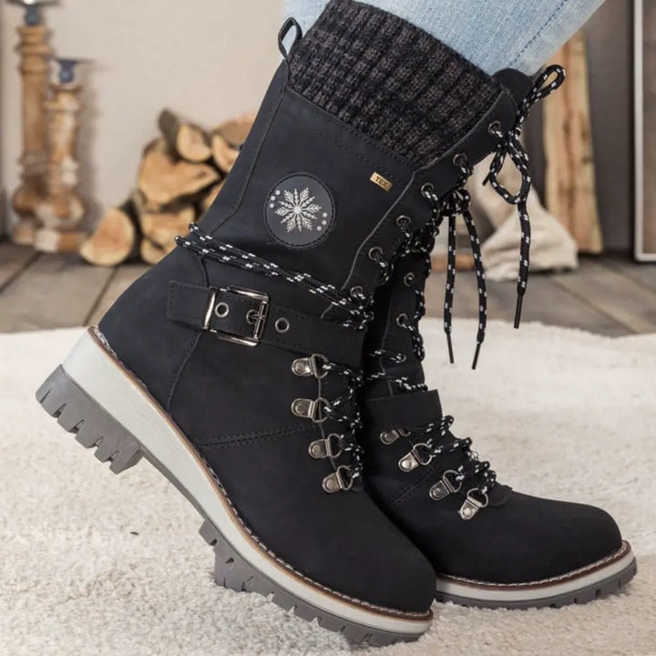 Women's lace-up snow boots with buckle strap and lug sole