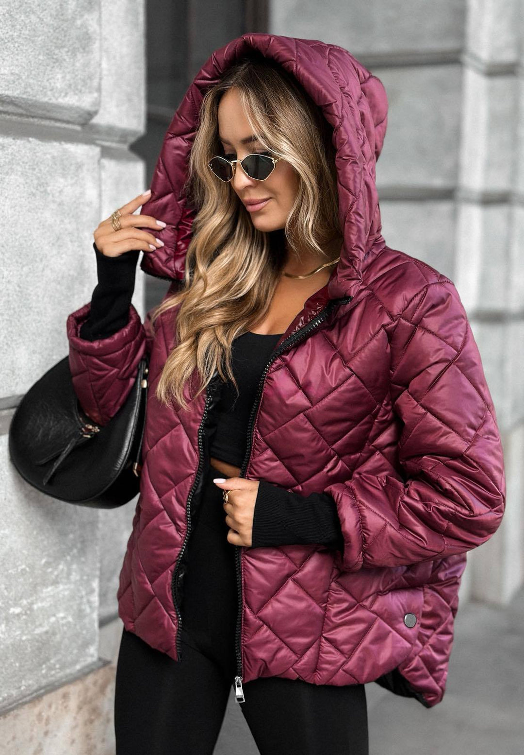 Women's quilted hooded puffer jacket with long sleeves and zip front