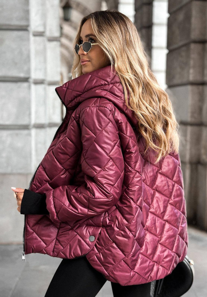 Women's quilted hooded puffer jacket with long sleeves and zip front