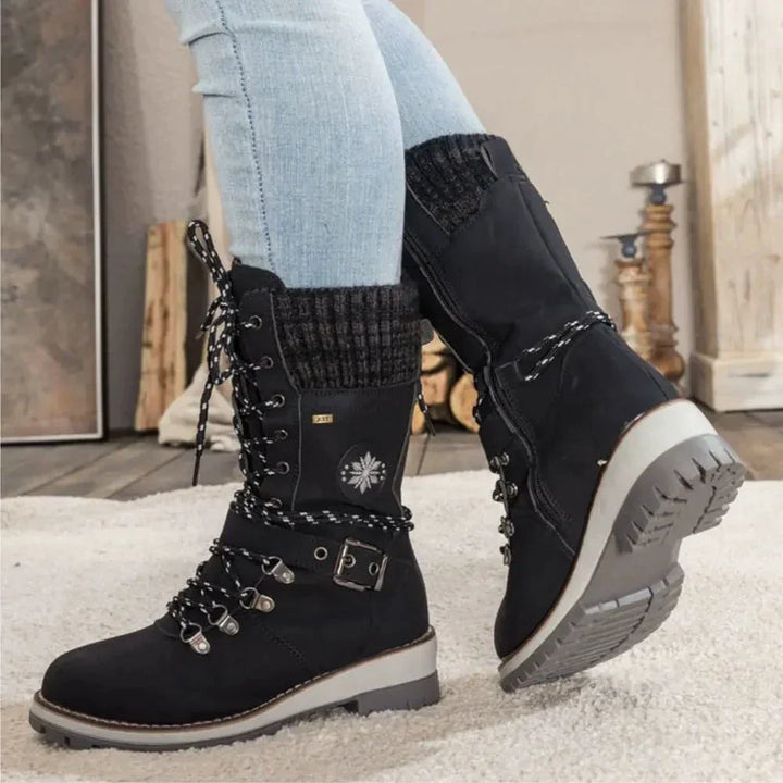 Women's lace-up snow boots with buckle strap and lug sole