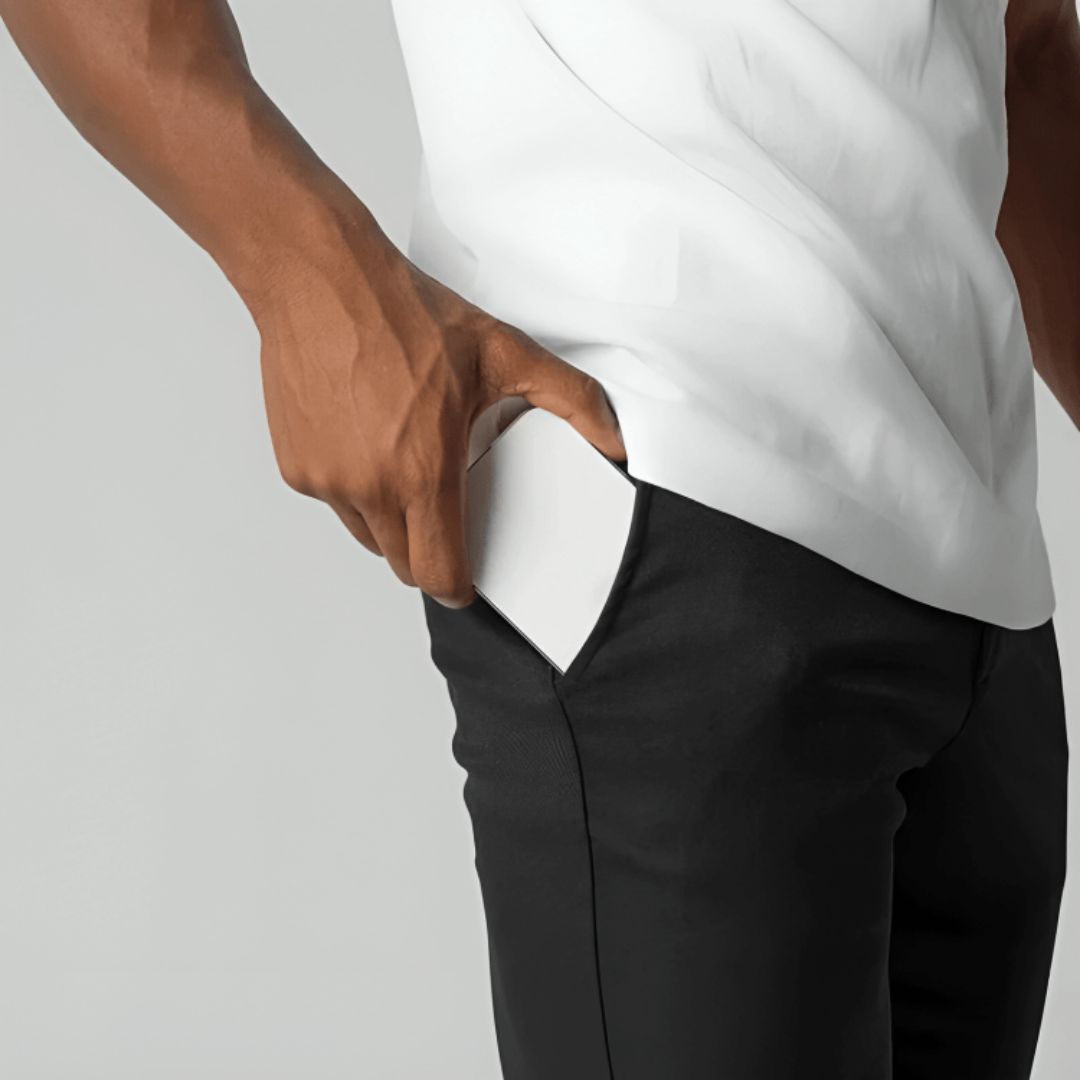 Men's slim tapered cropped chino pants shown in black and navy with side pockets and button closure
