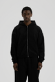 Man wearing a black full-zip hooded sweatshirt with a kangaroo pocket