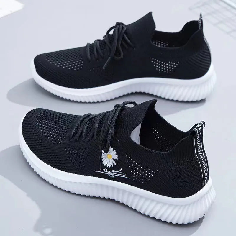 Women's textured lace-up sneakers with floral side detail and ridged soles
