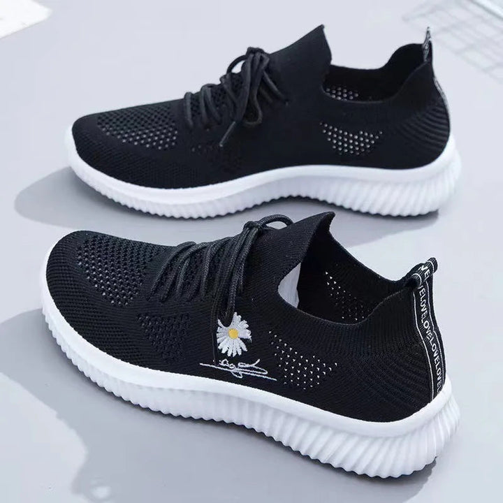 Women's textured lace-up sneakers with floral side detail and ridged soles