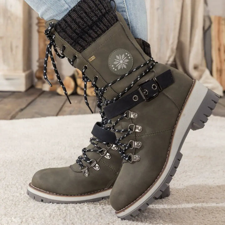 Women's lace-up snow boots with buckle strap and lug sole