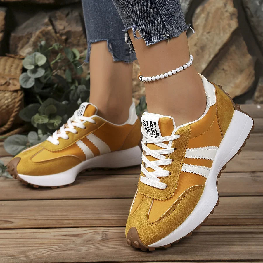 Women's black and white lace-up sneaker with striped side detail
