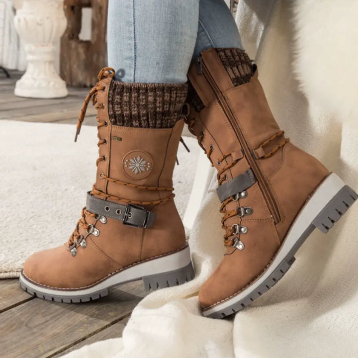 Women's lace-up snow boots with buckle strap and lug sole