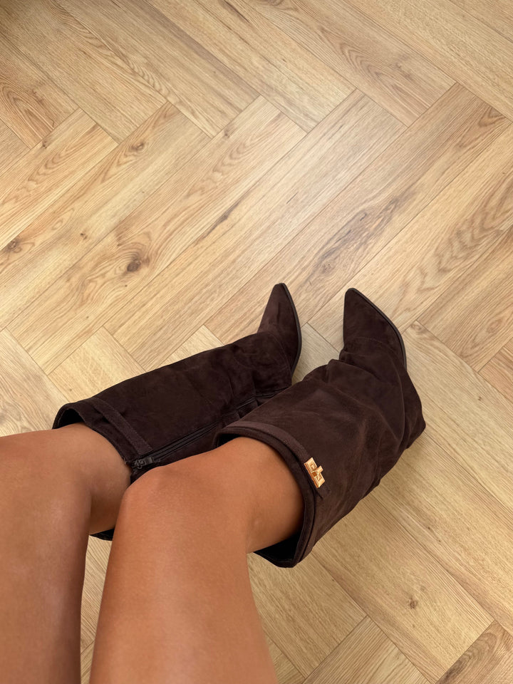 Women's brown knee-high boots with pointed toes, buckle straps and low block heels