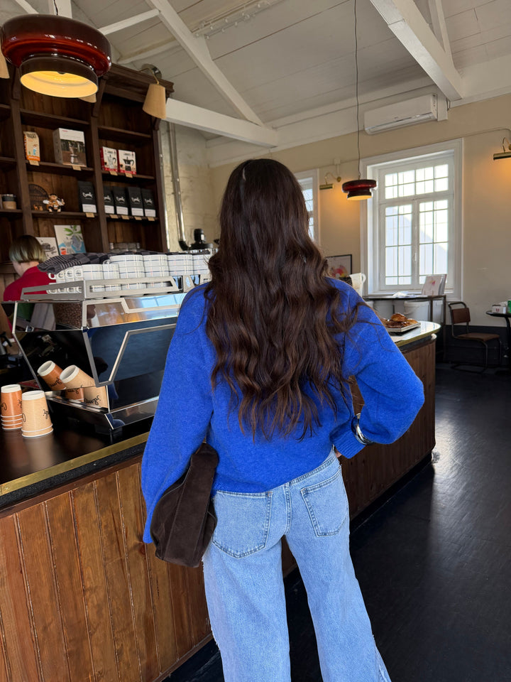 Women's blue long-sleeve V-neck knit sweater with ribbed trims