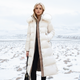 Women's longline quilted winter coat with fur-trim hood