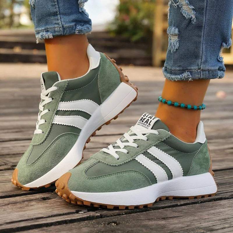 Women's black and white lace-up sneaker with striped side detail