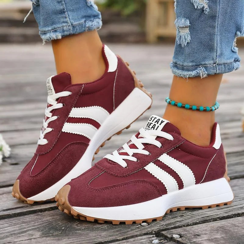 Women's black and white lace-up sneaker with striped side detail