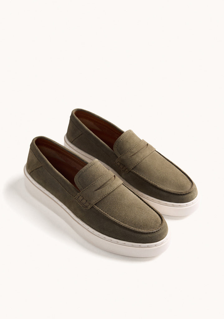 Green penny loafers with rounded moc toes and white platform soles