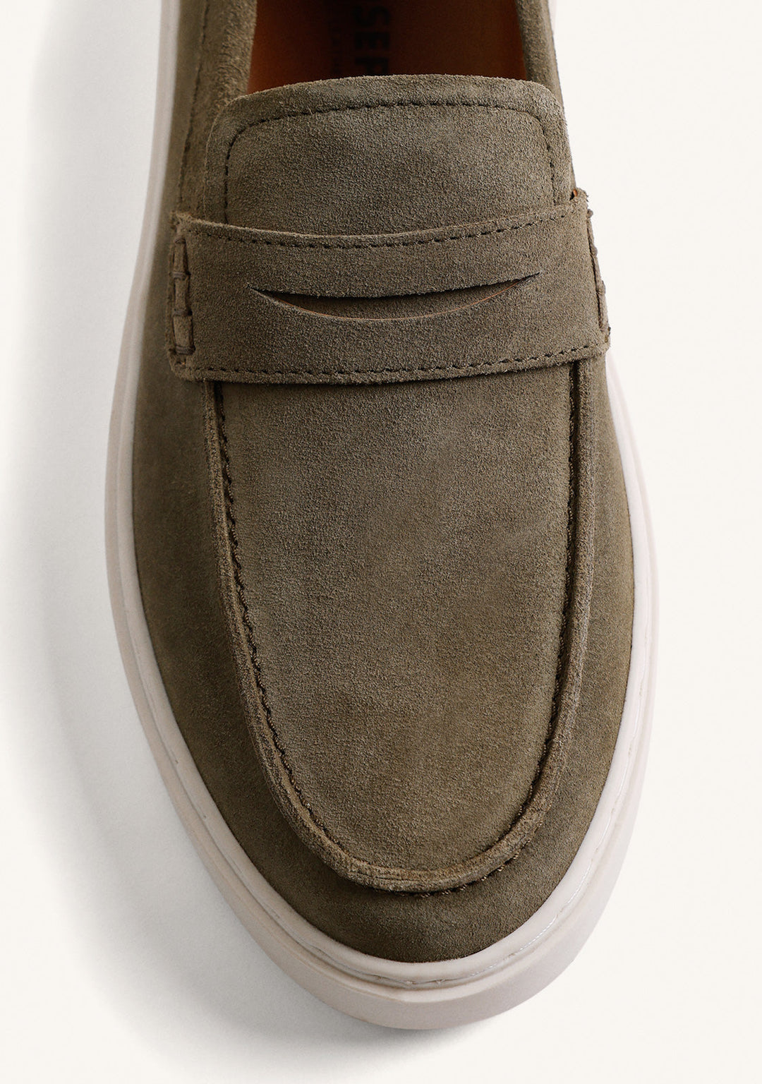 Green penny loafers with rounded moc toes and white platform soles